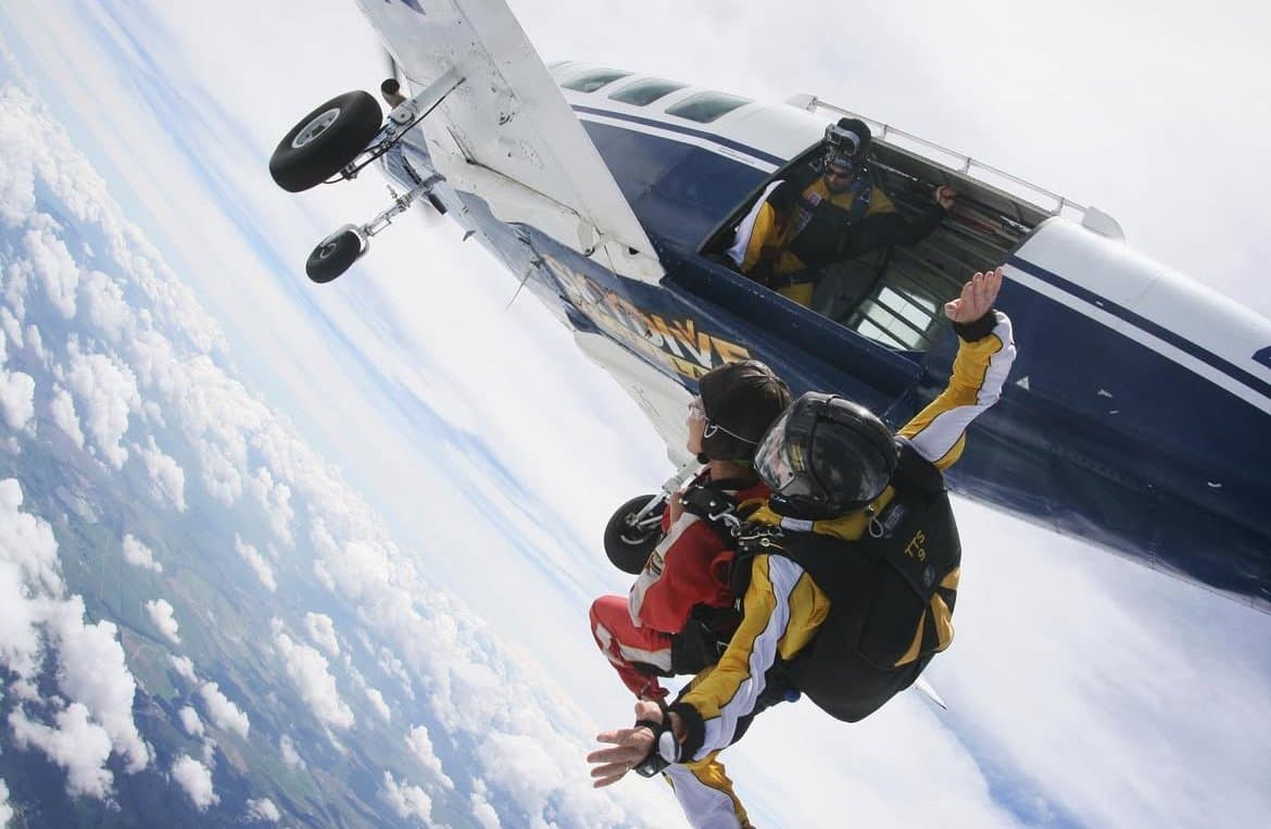 Skydiving from a plane above the clouds